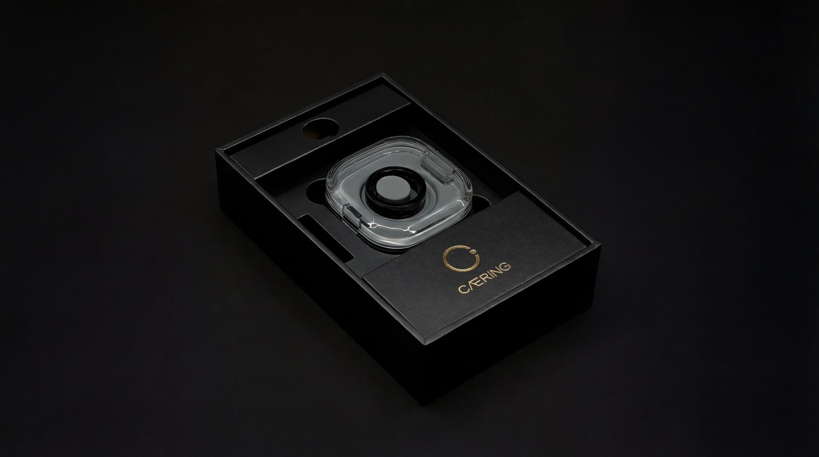 CAERING ring resting inside the open presentation box